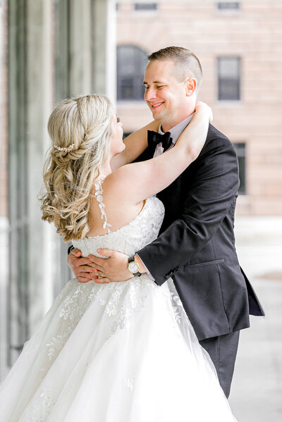 bride and groom embrace in  downtown Omaha