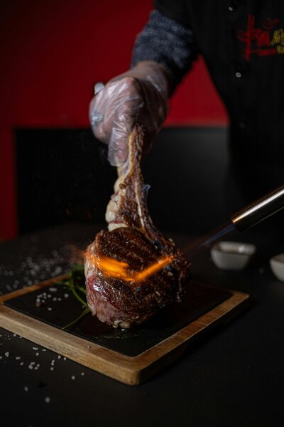 Perfectly seared Tomahawk steak at Mesquite Fork, featuring a rich, smoky crust and tender, juicy center for the ultimate Texas dining experience.