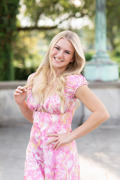 high school senior girl in floral dress posed at cleveland museum of art