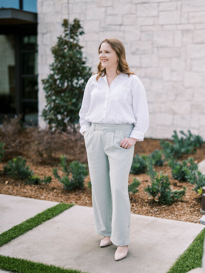 Shelby Austin wedding planner and founder of Plan On It Events smiles while setting a table