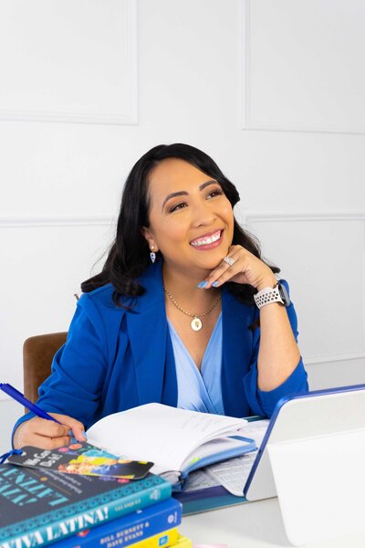 Career coaching services by HR Mami Career Coaching, showing a professional career development coach working in her office with blue brand pattern accents