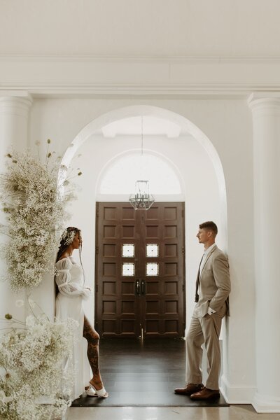 bride and groom standing in entry way
