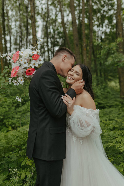 Bride and groom sharing a kiss during their Minneapolis wedding captured by Ivy Christina Photos.