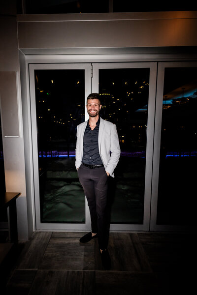 Andrew Cooper, Lead Photographer at Bambino International, specializes in creating photographic narratives that tell each couple's unique story. This image features him at a wedding, skillfully capturing every heartfelt moment with his distinctive artistic touch.