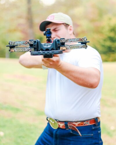 Senior portrait of a young man shooting his bow