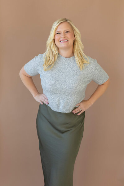 women in blue dress on grey background in photography studio