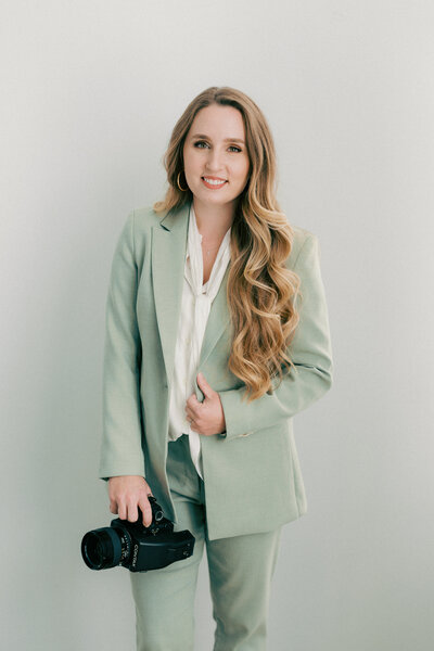 Wedding photographer Rachel Linder sitting on a white chair
