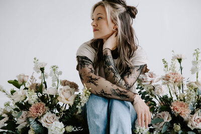 woman sitting with flowers