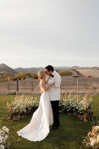 The bride and groom sharing a joyful moment at Carneros Resort, with breathtaking views of Napa Valley’s rolling hills.