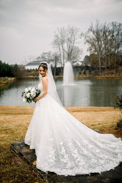 Bridal portrait outside near fountain at Little River Farms  Wedding Venue in Milton Georgia