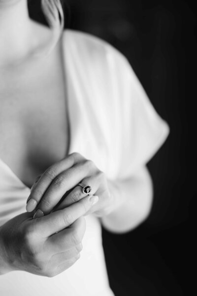Black and White elegant wedding photo of bride holding her engagement ring.