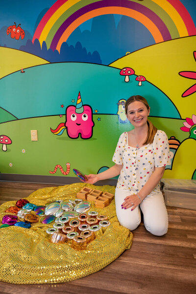 Female entrepreneur showing off kid's sensory toys for personal branding session for her music program for Children in a newly opened space in downtown Westport, CT.