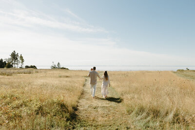 couple embracing on beach in pei for lifestyle photos