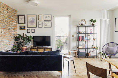 Modern apartment living room with exposed brick wall and stylish furniture.