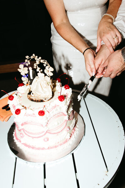 Vintage style cake cutting close up at wedding