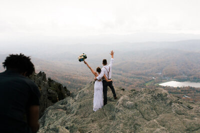 Luxury Wedding Portraits by Moving Mountains Photography in NC - Photo of a couple on their wedding day with a mountainous background.