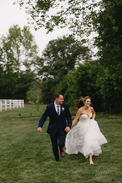 Bride and groom walking in the field