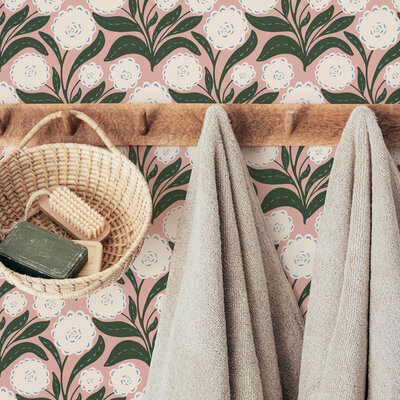 Wallpapered walls of a bathroom in a floral print of white blooms, green leaves, and a pink background. Boho, bohemian, feminine, botanical