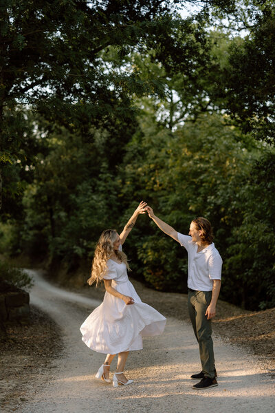 A couple popping champagne during their engagement session at Scottsdale Farm, near Milton, Ontario