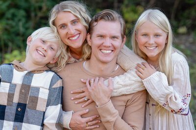 Family smiles on in an epic golden hour lighting session in Cottonwood Canyon, Utah