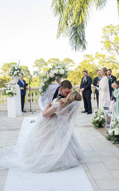 Groom dipping bride down the aisle in a St Augustine FL wedding