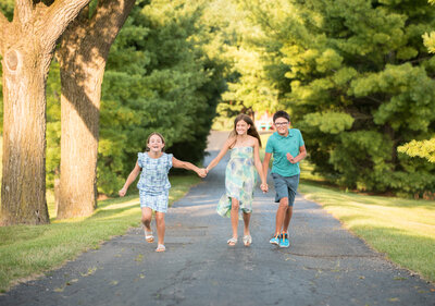 Kids having fun running down a road near Lake Maxinkuckee as they finish their family pictures.
