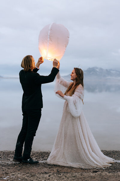 a destination elopement couple lighting a lantern