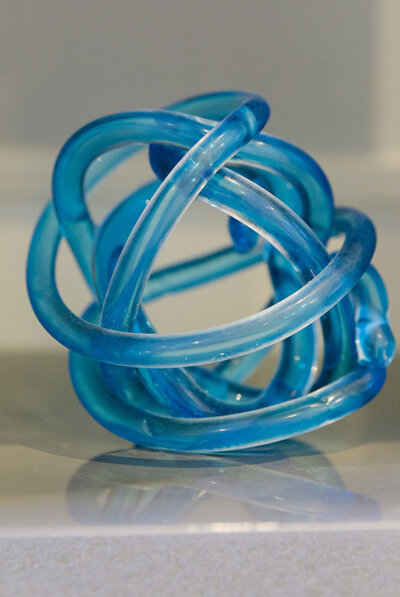 Glass blue decorative knot for shelf display