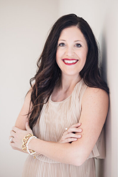 Woman sitting on couch, smiling