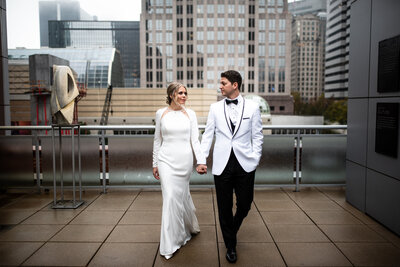 Luxury Wedding Portraits by Moving Mountains Photography in NC - Photo of a couple on their wedding day with a skyscraper background.