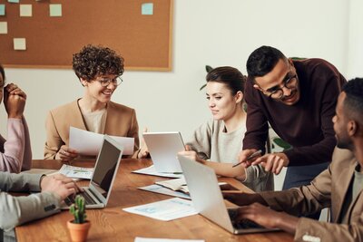 A diverse group of professionals engaged in a meeting, discussing ideas