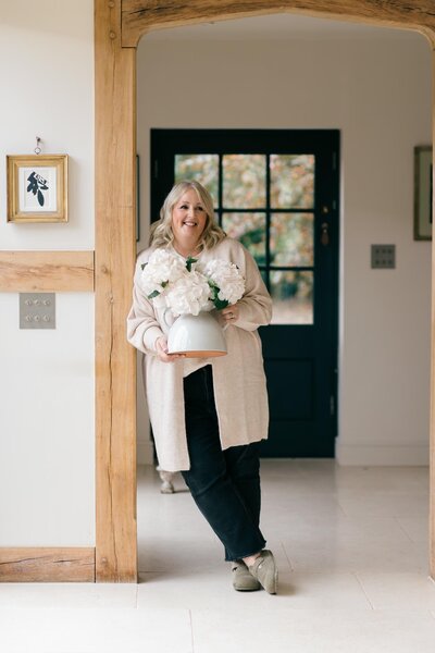 Cornwall wedding florist Anna Sawle putting the final touches to her table display for a beach marquee wedding