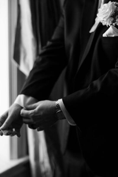 Groom adjusting cuffs