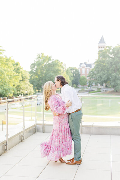 engaged couple kissing at clemson university campus