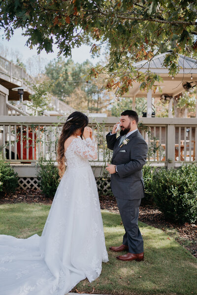 Newlyweds pose on a couch
