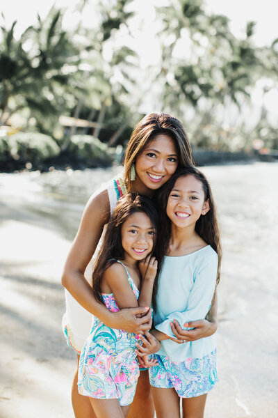 mother and daughters on beach in maui