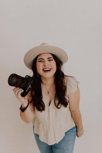woman holding camera and smiling