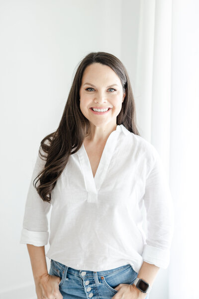 Connecticut newborn and family photographer, Kristin Wood, smiles for portrait in white blouse