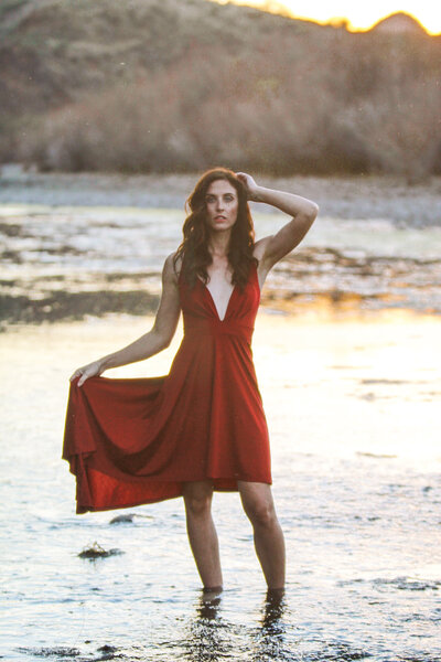 Red Dress Model on beach during sunste
