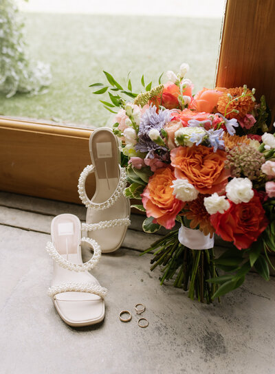 Bright, bold, and full of personality—this East Tennessee wedding detail shot highlights the bride’s pearl heels, vibrant summer bouquet, and classic gold wedding bands. Every element was carefully chosen and captured with a documentary-style eye for natural, meaningful moments.