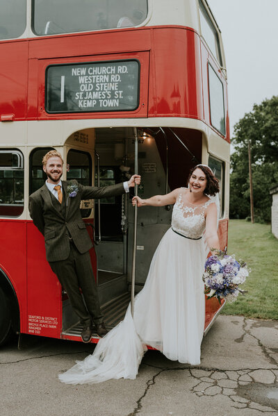 Bride and Groom hanging on a london red bus