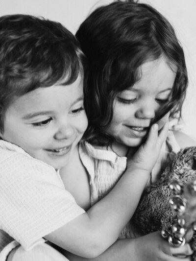 two siblings embracing each other