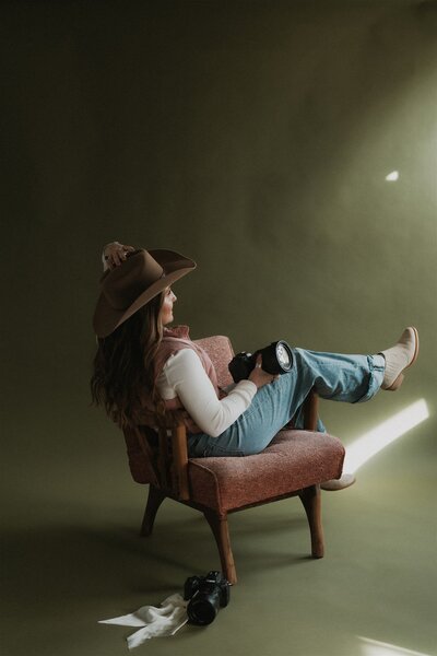 Studio portrait of a Wyoming-based wedding and lifestyle photographer, captured in a clean and professional setup with soft lighting and a relaxed pose.