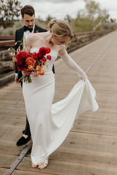 Spring wedding bouquet with protea, lilies, and garden roses