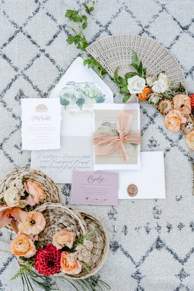 flatlay image of wedding invitations and flowers