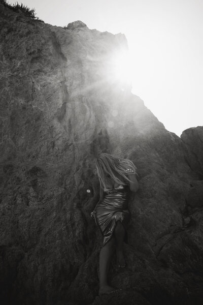 Nicky Lynn on the beach in a gold dress at sunset, embodying transformation and inner confidence
