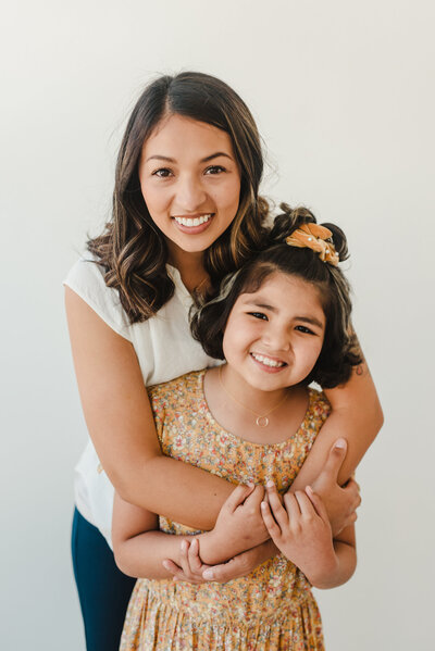 a mom hugging her daughter