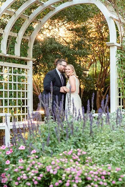 Destination wedding photographer photo of couple in lilac field