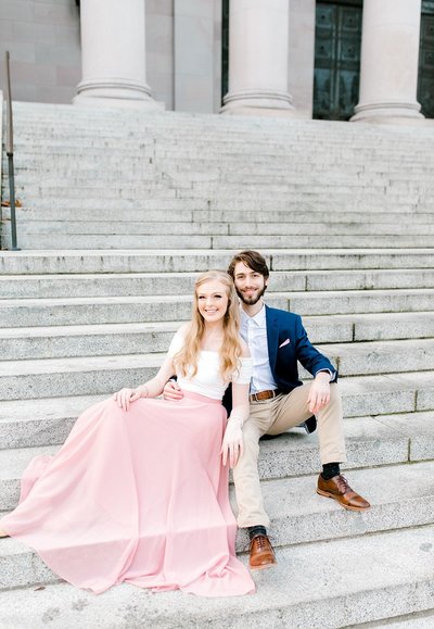 two wedding photographers sitting on outdoor steps