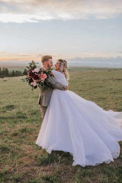 Sacramento Wedding Photographer captures groom spinning bride around during portraits